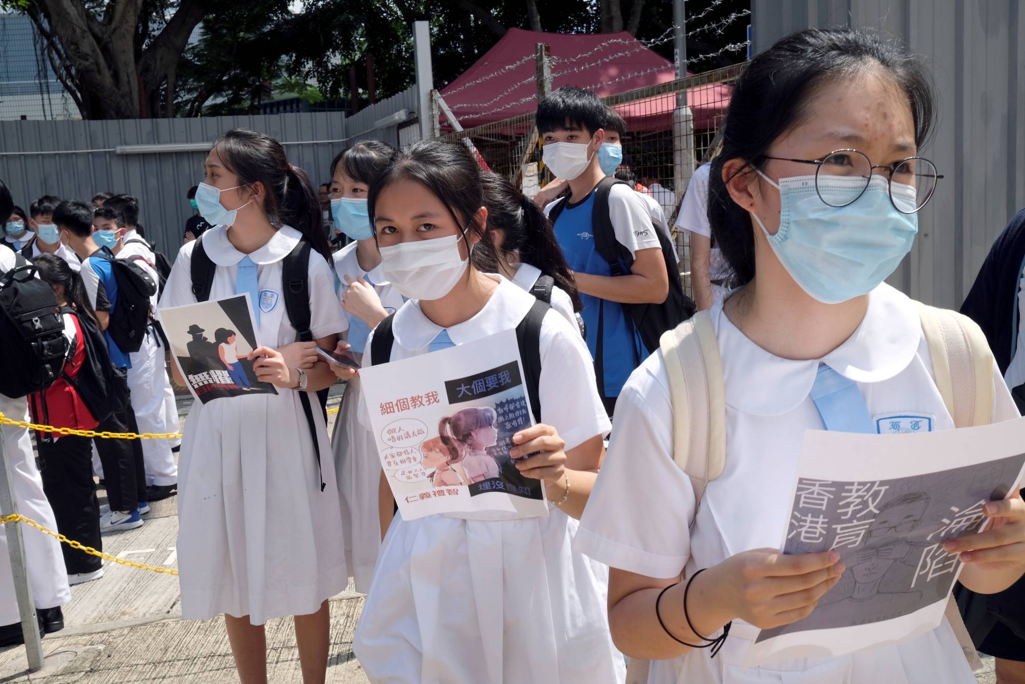 Students march near Heung To Middle School in Hong Kong in June to protest against what the students say is the nonrenewal of a teacher's contract over her political beliefs. | Reuters 