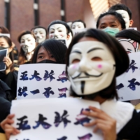 University students pose during a news conference to support anti-government protests before their graduation ceremony at the Hong Kong Polytechnic University in November 2019.  | REUTERS 