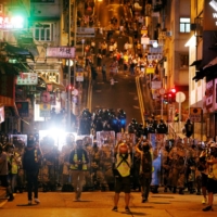 Police officers line up during a protest against what activists see as excessive police force against protesters during previous demonstrations, near China\'s Liaison Office in Hong Kong in July 2019.  | REUTERS 