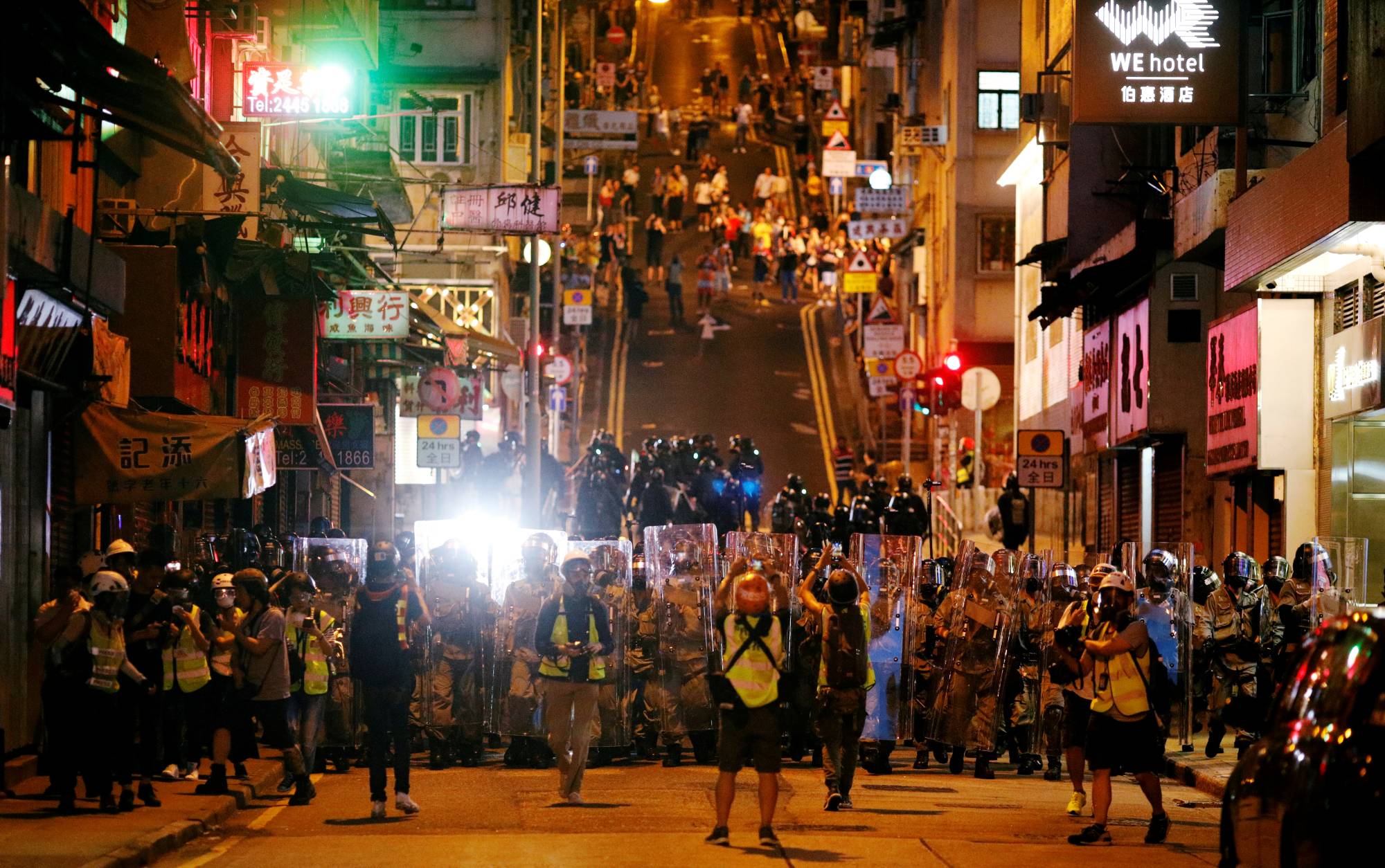 Police officers line up during a protest against what activists see as excessive police force against protesters during previous demonstrations, near China's Liaison Office in Hong Kong in July 2019. | Reuters 