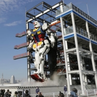 A life-size moving statue of Gundam is shown to the media Monday at Yamashita Pier in Yokohama. | KYODO