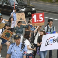 Young people march against climate change in Osaka, in June 2019, ahead of a summit of the Group of 20 economies. | KYODO
