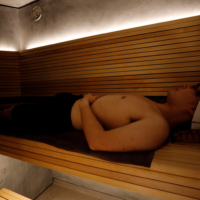 Kotaro Nakahira, a staff member of Solo Sauna Tune, uses its private Finnish-style sauna room during a demonstration. | REUTERS