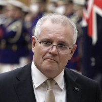 Australian Prime Minister Scott Morrison reviews an honor guard during a ceremony ahead of a meeting with Prime Minister Yoshihide Suga in Tokyo on Nov. 17. | POOL / VIA AP