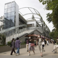 Pedestrians walk by the redeveloped Miyashita Park in Tokyo\'s Shibuya Ward. | AP
