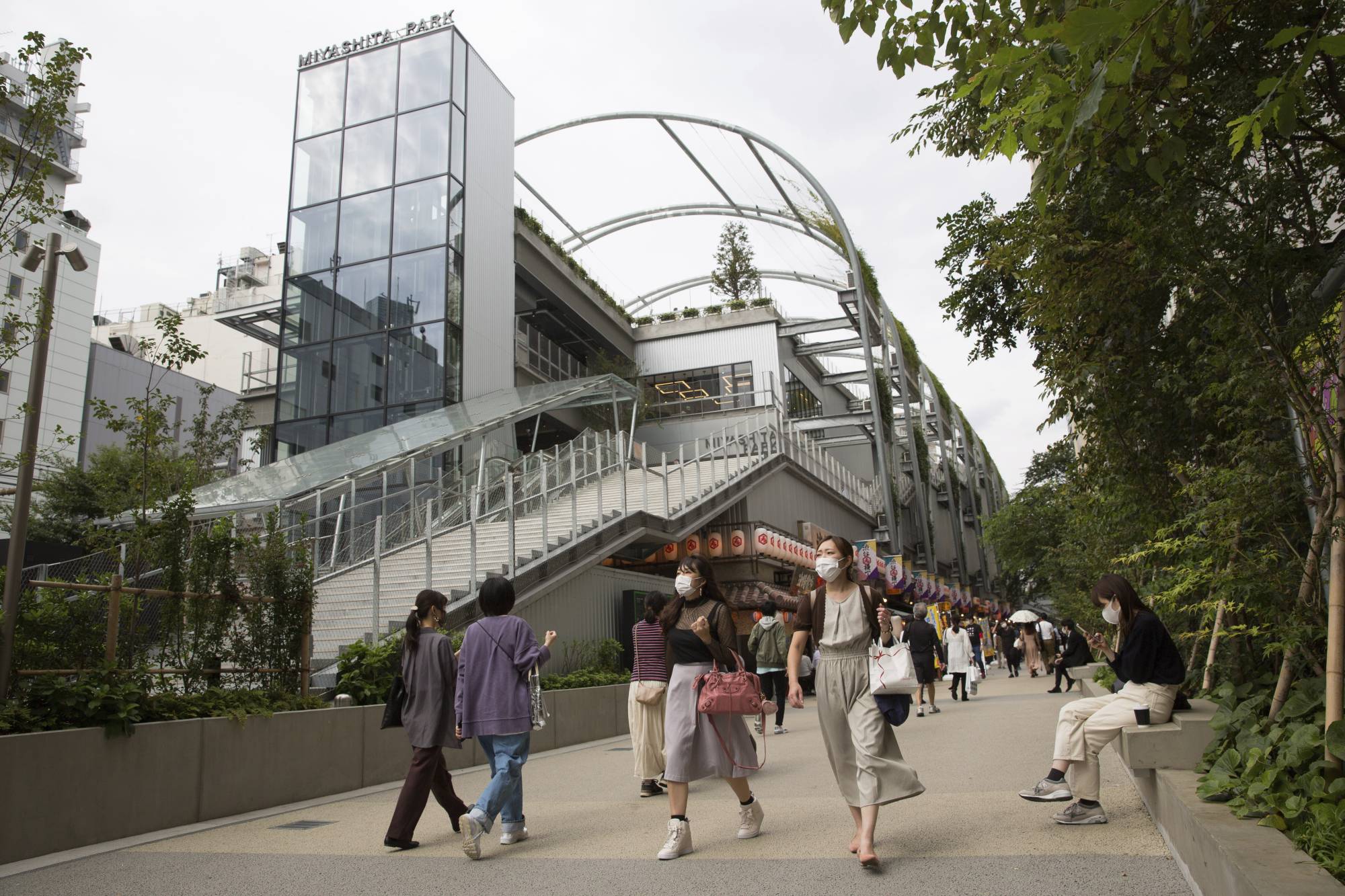 Pedestrians walk by the redeveloped Miyashita Park in Tokyo's Shibuya Ward. | AP 