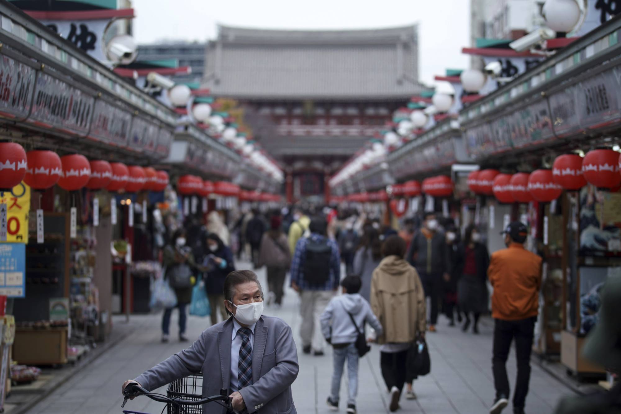 People walk through a shopping arcade in the Asakusa district in Tokyo on Nov. 24. |  AP