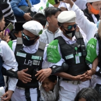 Supporters of Rizieq Shihab, leader of the Islamic Defenders Front, gather at the organization\'s headquarters in Jakarta on Nov. 10. | AFP-JIJI