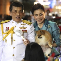 Thai King Maha Vajiralongkorn and Queen Suthida meet supporters in Bangkok on Nov. 25. | AP
