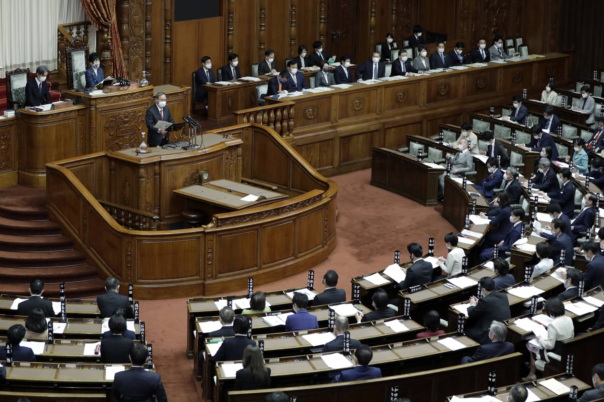Prime Minister Yoshihide Suga speaks during a plenary session at the Upper House in Tokyo on Monday. | BLOOMBERG