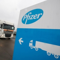 A refrigerated truck leaves the Pfizer plant in Puurs, Belgium, on Thursday.  | REUTERS