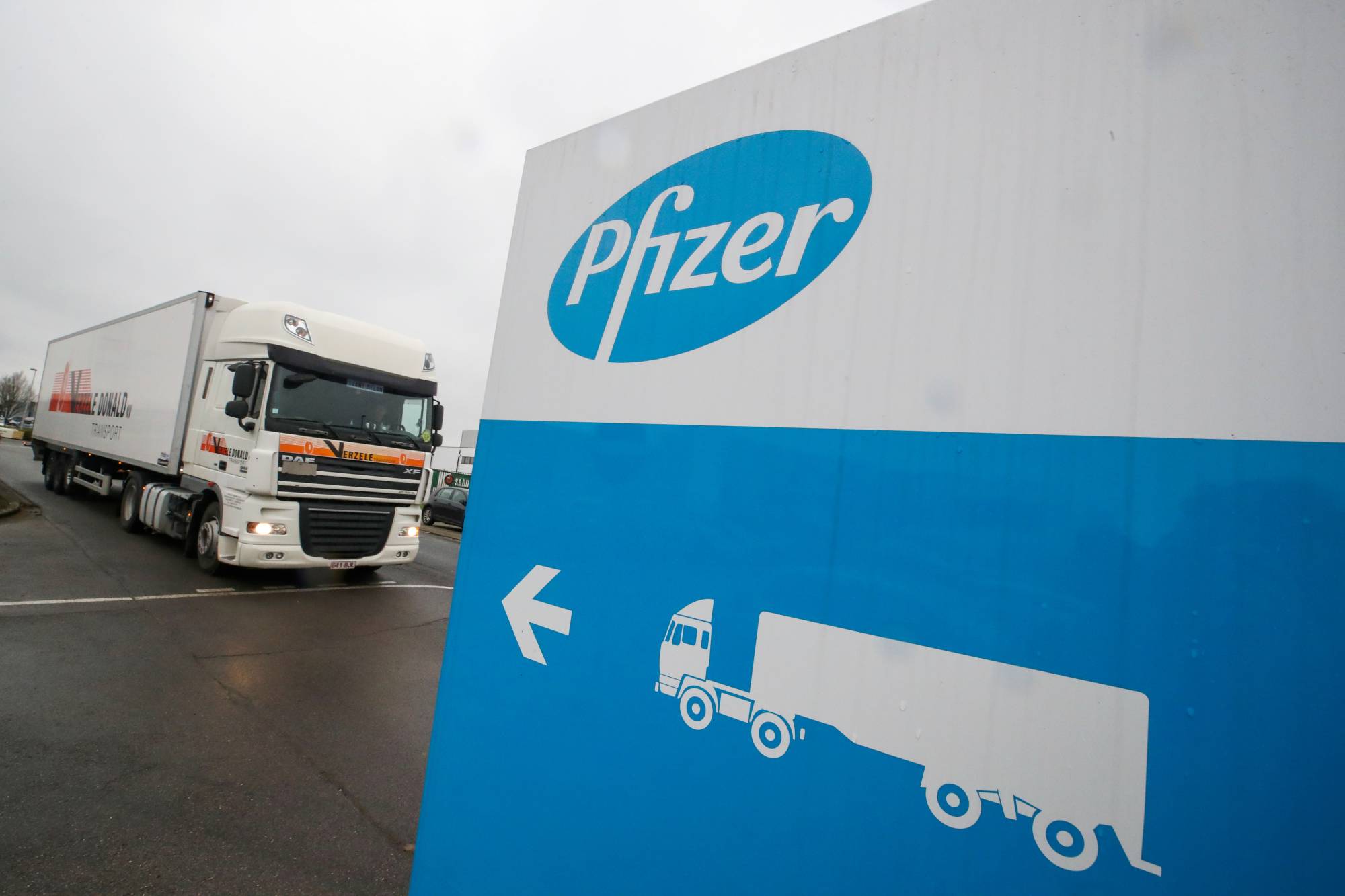 A refrigerated truck leaves the Pfizer plant in Puurs, Belgium, on Thursday. | REUTERS