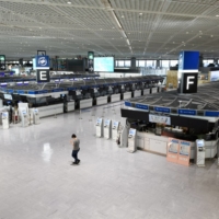 Closed doors: Narita Airport, seen here in July, was a hive of activity before the pandemic hit. To stop the spread of COVID-19, Japan\'s government closed the borders to everyone but Japanese citizens, causing difficulties for many non-Japanese residents. | AKIO KON / BLOOMBERG
