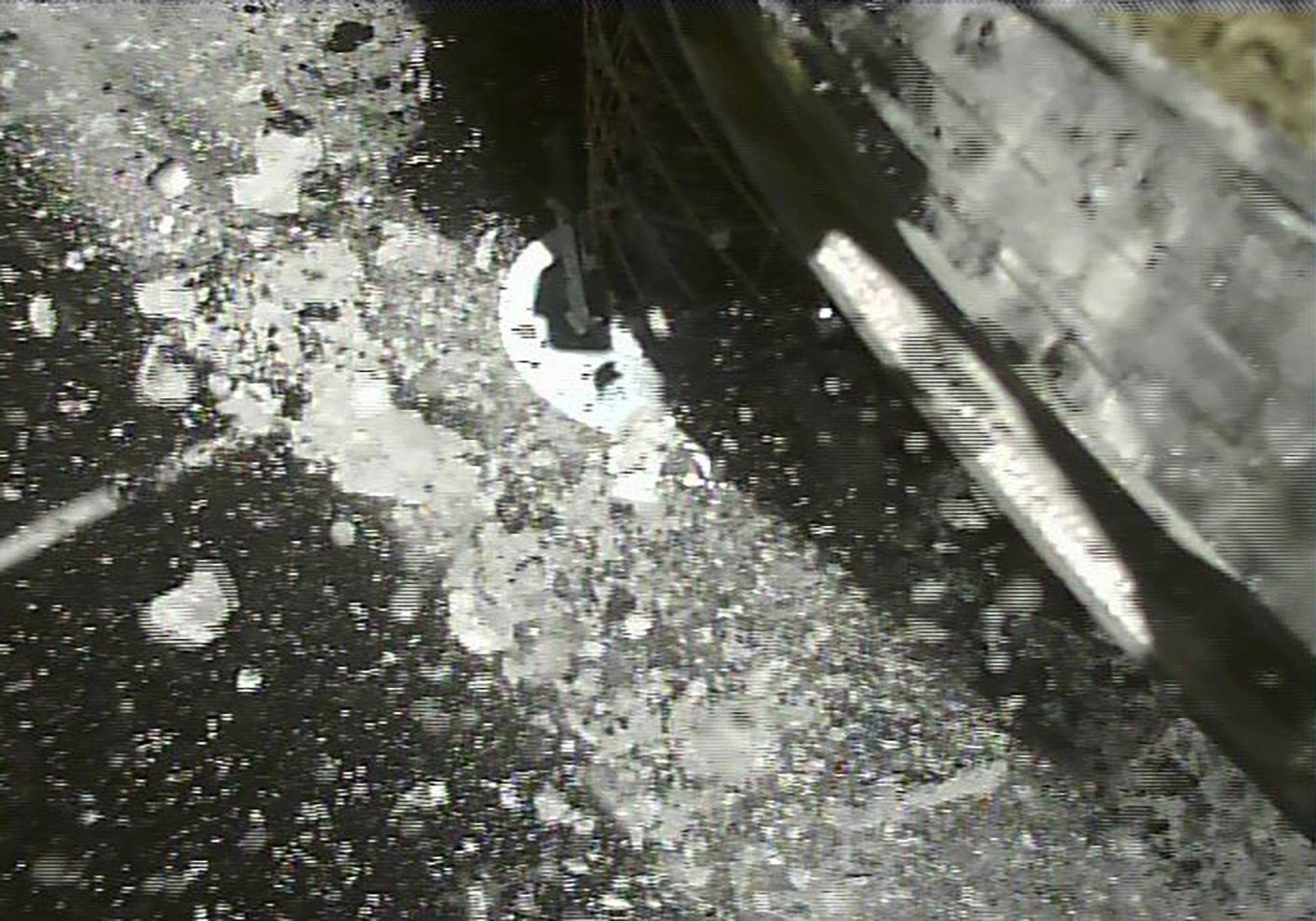 The Hayabusa2 spacecraft lands on an asteroid to collect samples in this image released in July 2019. | JAXA / VIA AP