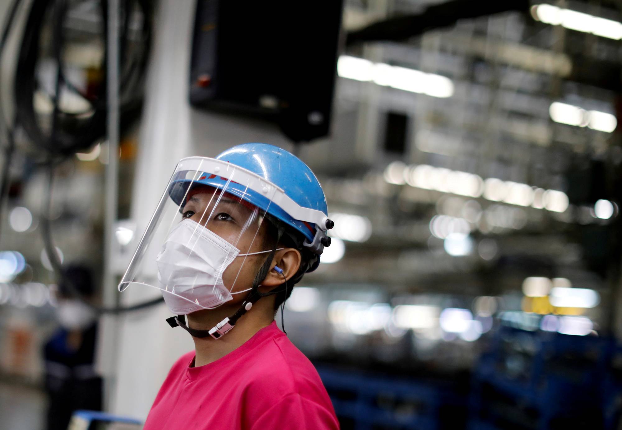 An employee works on a Mitsubishi assembly line in Kawasaki on May 18. | REUTERS