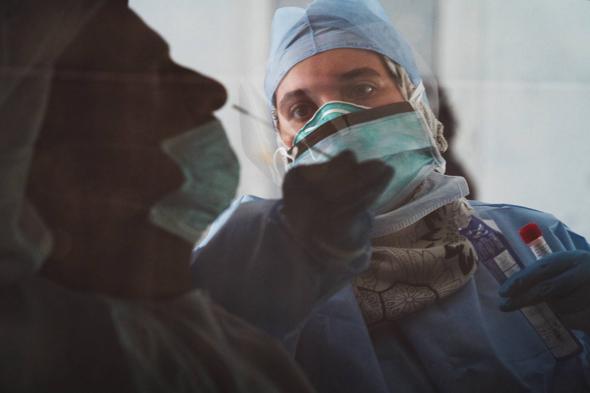 A technician takes a nasal swab for a coronavirus detection test at a drive-thru testing facility in Abu Dhabi. China’s state-backed coronavirus vaccine protected 86% of people from getting COVID-19 in trials conducted in the United Arab Emirates.  | AP