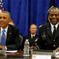 Then-U.S. President Barack Obama sits next to then-Central Command chief Gen. Lloyd Austin during a briefing from top military leaders at MacDill Air Force Base in Tampa, Florida, in September 2014. | REUTERS