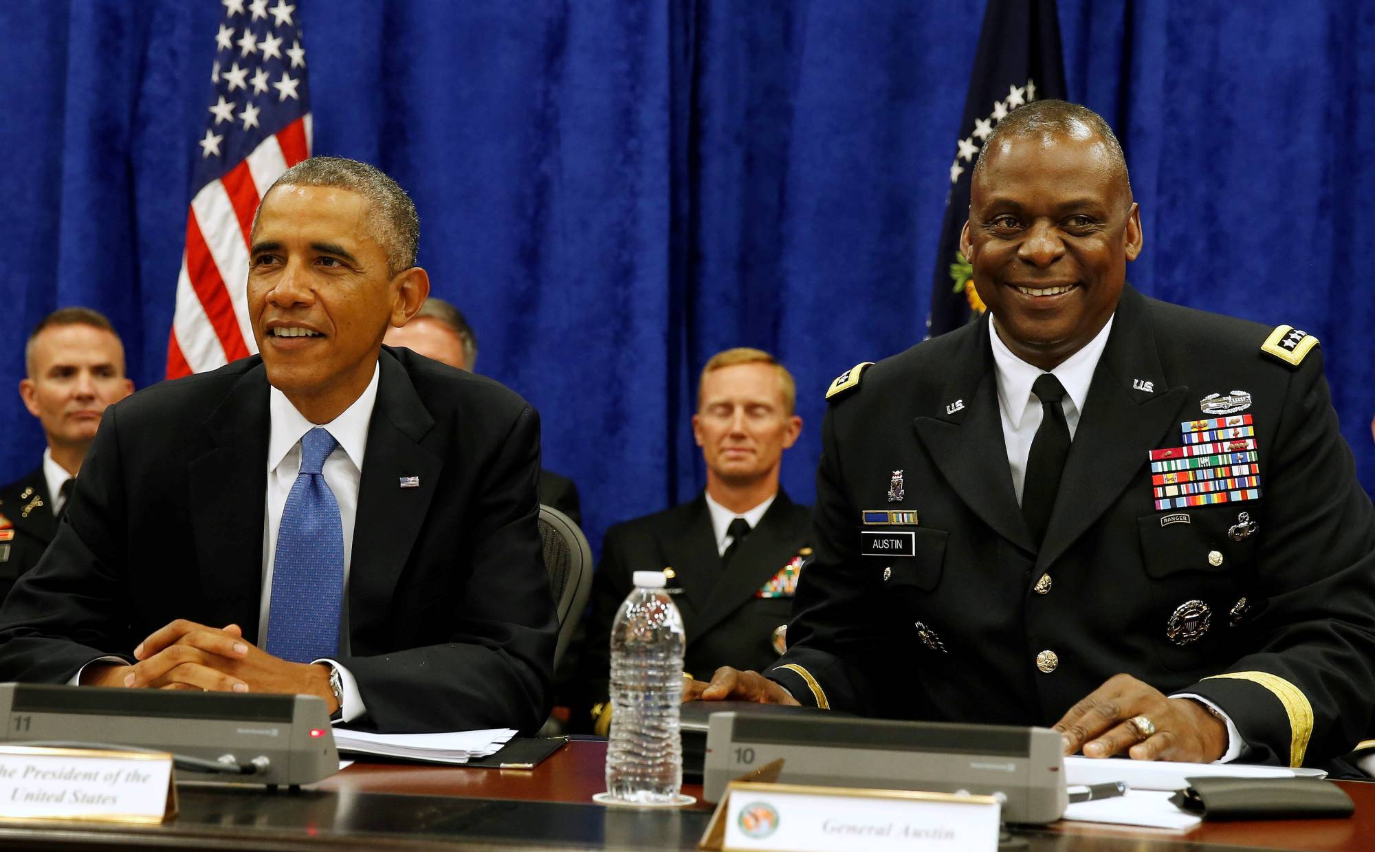 Then-U.S. President Barack Obama sits next to then-Central Command chief Gen. Lloyd Austin during a briefing from top military leaders at MacDill Air Force Base in Tampa, Florida, in September 2014. | REUTERS