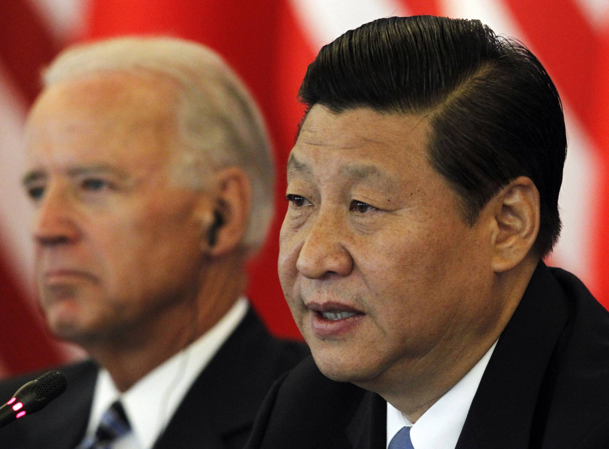 Then-Chinese Vice President Xi Jinping speaks next to then-U.S. Vice President Joe Biden during talks at a hotel in Beijing in August 2011. | POOL / VIA REUTERS