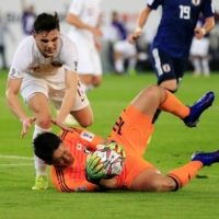 Japan goalkeeper Shuichi Gonda dives to collect the ball against Qatar during the 2019 Asian Cup final on Feb. 1, 2019, in Abu Dhabi. | REUTERS