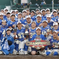 Kwansei Gakuin players pose for photos after winning the Koshien Bowl against Nihon University on Sunday in Nishinomiya, Hyogo Prefecture. | KYODO