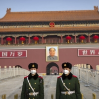 Paramilitary police stand guard at Tiananmen Gate, adjacent to Tiananmen Square, in Beijing in January. China’s current swaggering mood could add to the challenges facing Joe Biden when he takes office as U.S. president. | AP