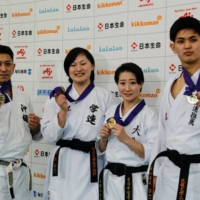 Ryo Kiyuna, Yuzuki Sawae, HIkaru Ono and Yusei Sakiyama pose after winning titles at the 48th All-Japan Karatedo, the national karate championships, on Sunday. | KAZ NAGATSUKA