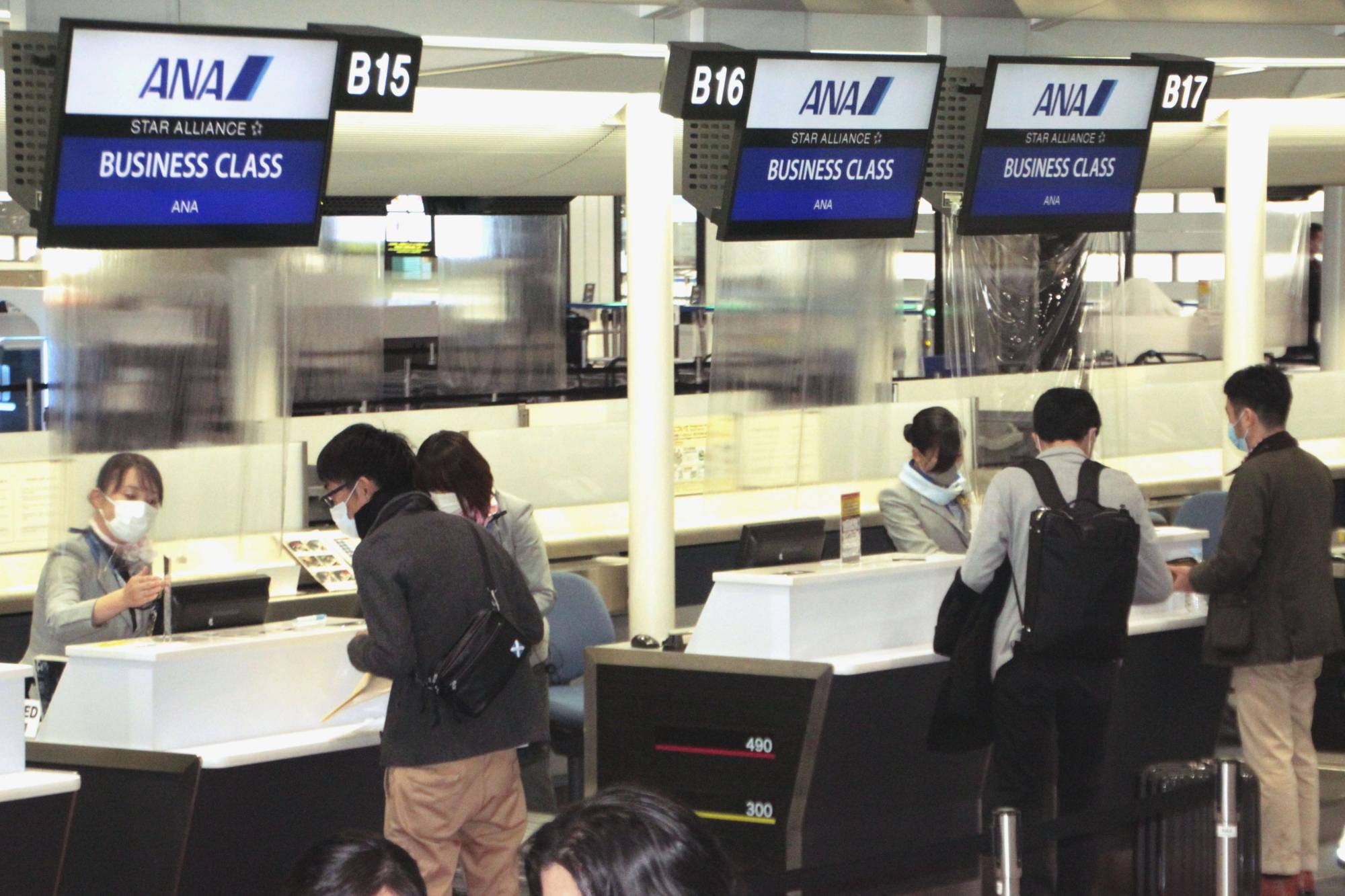 Passengers go through boarding procedures at an All Nippon Airways check-in counter for the airline's inaugural flight to Shenzhen at Narita Airport in Chiba Prefecture on Monday. | KYODO