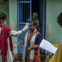 A health care worker conducts an examination in Ganjam, a rural district of India that was untouched by the coronavirus until migrant workers began to return home. | ATUL LOKE / THE NEW YORK TIMES