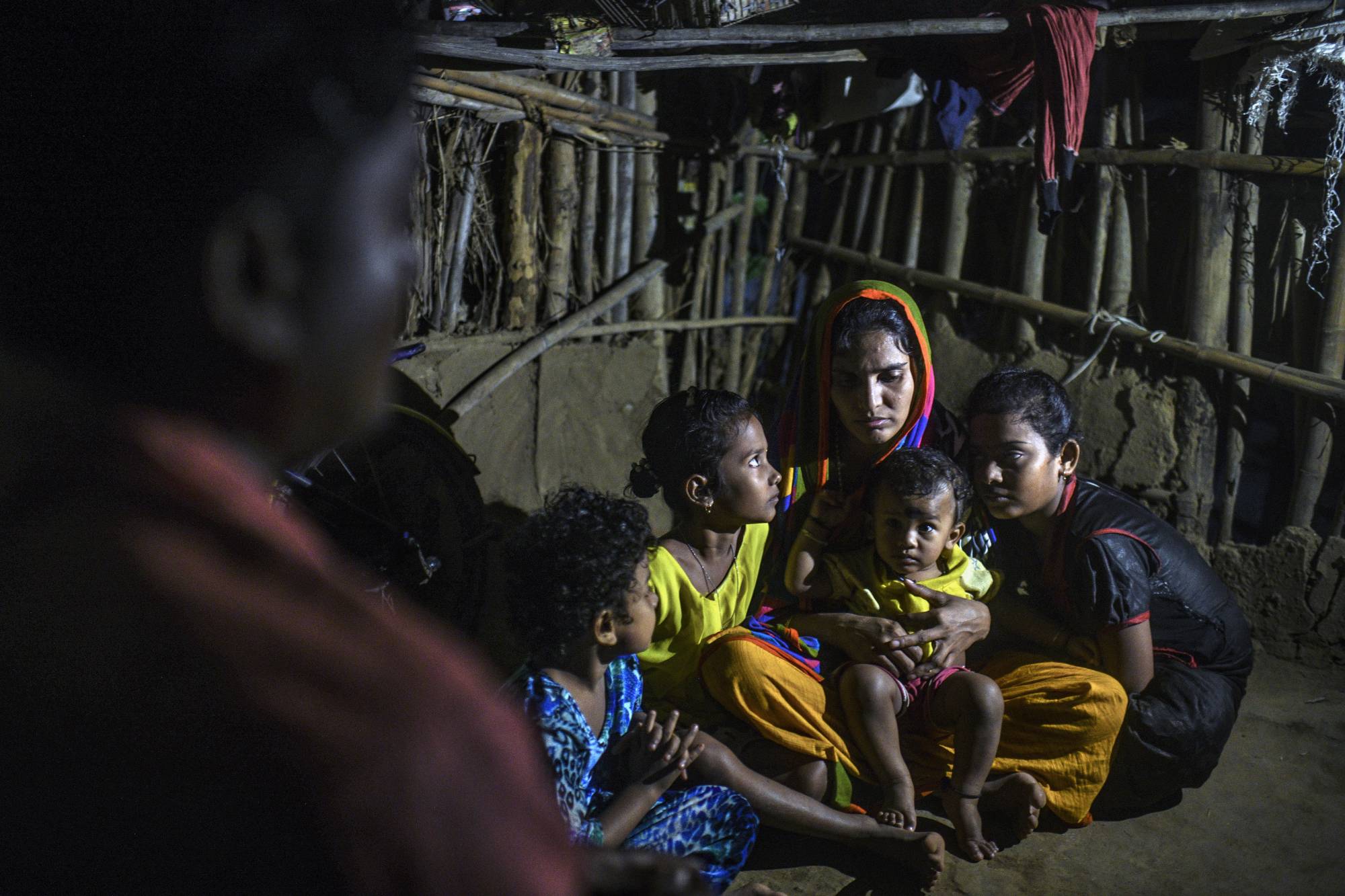 Rita Behera, the widow of Prafulla Behera, with their four daughters on Nov. 10 in Ganjam, India | Atul Loke / The New York Times