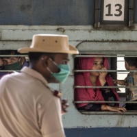 Migrant workers and their families in a crowded train in Mumbai on May 20. It has become clear that special trains operated by the government to ease suffering — and to counteract a disastrous lack of lockdown planning — instead played a significant role in spreading the coronavirus into almost every corner of the country. | ATUL LOKE / THE NEW YORK TIMES