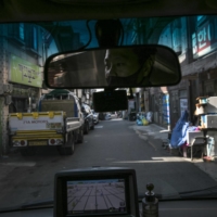Park Ki-Ryeon drives his delivery truck along a narrow street in Seongnam, near Seoul.  | WOOHAE CHO / THE NEW YORK TIMES