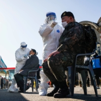 A South Korean soldier undergoes a coronavirus test in Seoul on Tuesday.  | REUTERS