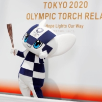 Tokyo 2020 Olympic mascot Miraitowa holds the Olympic torch during an event in Tokyo on June 1, 2019. | REUTERS