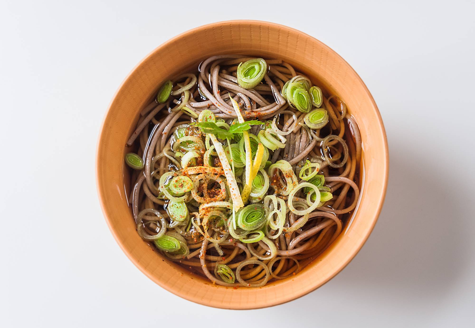 Comfort food: For a much simpler toshikoshi (“year-crossing”) soba, serve the noodles and soup topped with chopped leek or green onion, shredded yuzu citrus peel and shichimi tōgarashi spice mix. | Makiko Itoh 