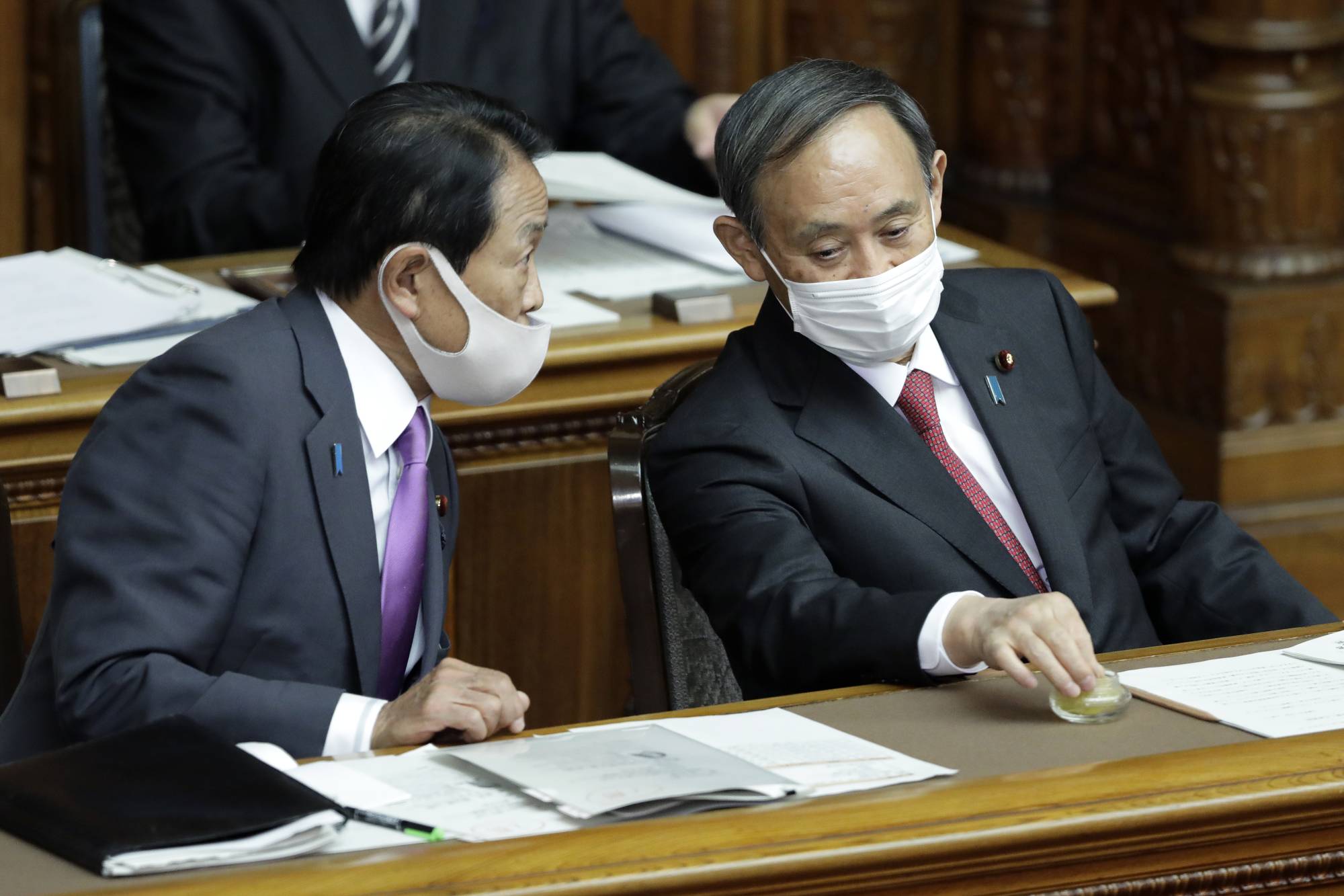 Prime Minister Yoshihide Suga's power atop the government is not assured in the coming year, and with some significant elections scheduled, domestic politics could once again shake things up at the top. | BLOOMBERG