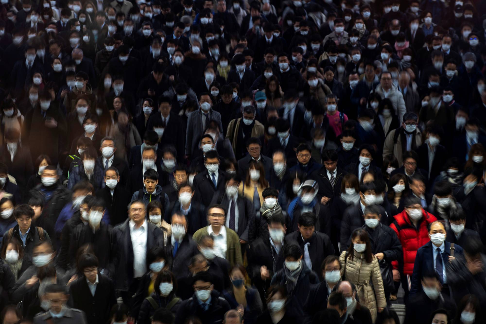 Commuters walk through Shinagawa Station in Tokyo on March 2. | REUTERS