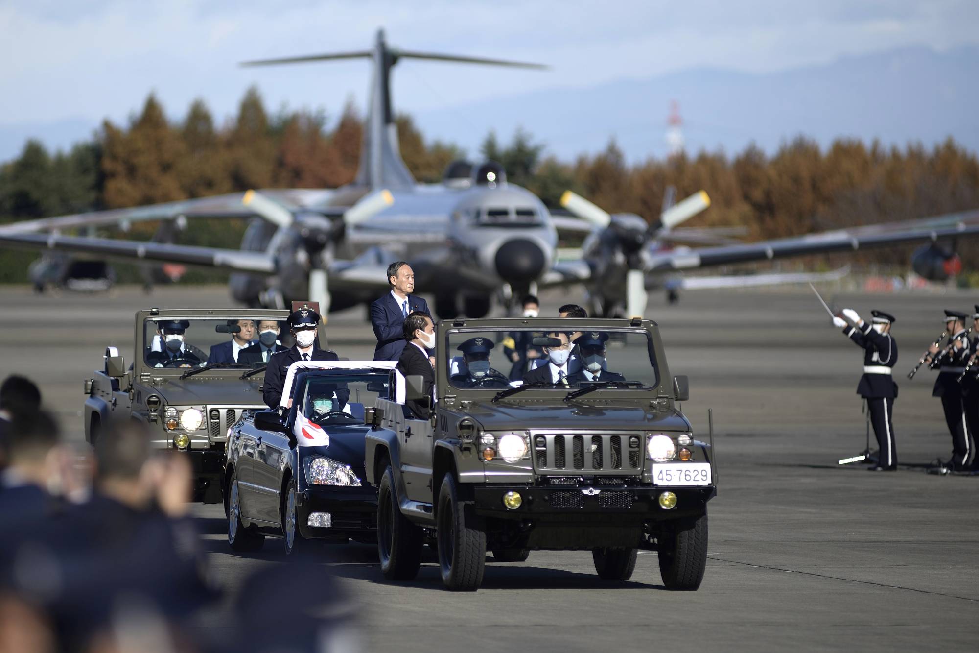 Prime Minister Yoshihide Suga conducts a review in November at Iruma Air Base in Sayama, Saitama Prefecture, operated by the Air Self-Defense Force. Suga's Cabinet approved a record defense budget for fiscal 2021 on Monday. | POOL / VIA REUTERS