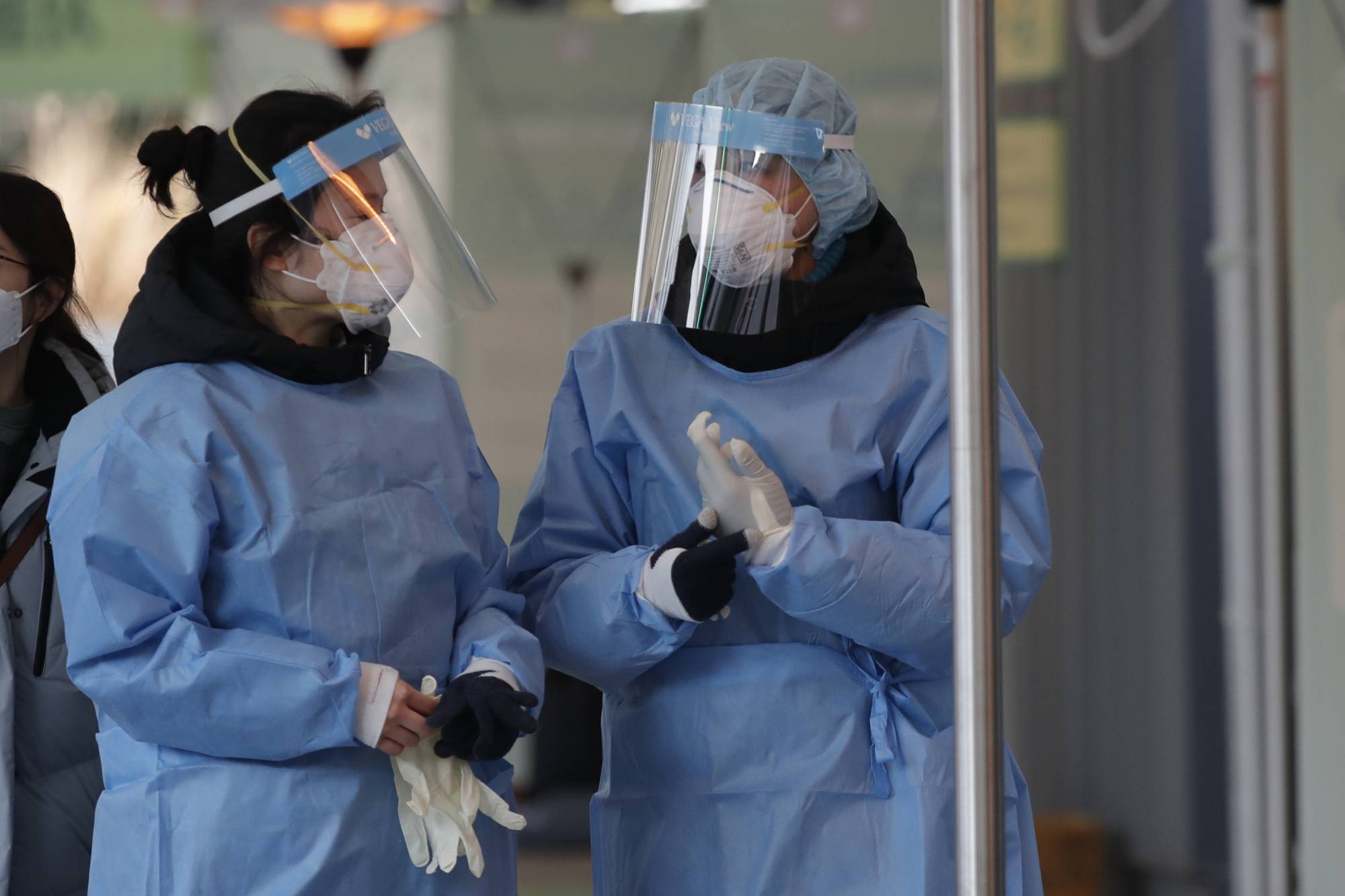 Medical workers at a testing site in Seoul on Monday. | AP
