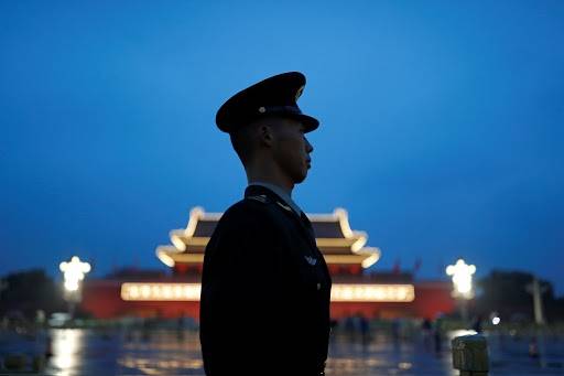 A paramilitary police officer stands guard during a flag-raising ceremony at Tiananmen Square on National Day, marking the 71st anniversary of the founding of People's Republic of China, in Beijing on Oct. 1. | REUTERS