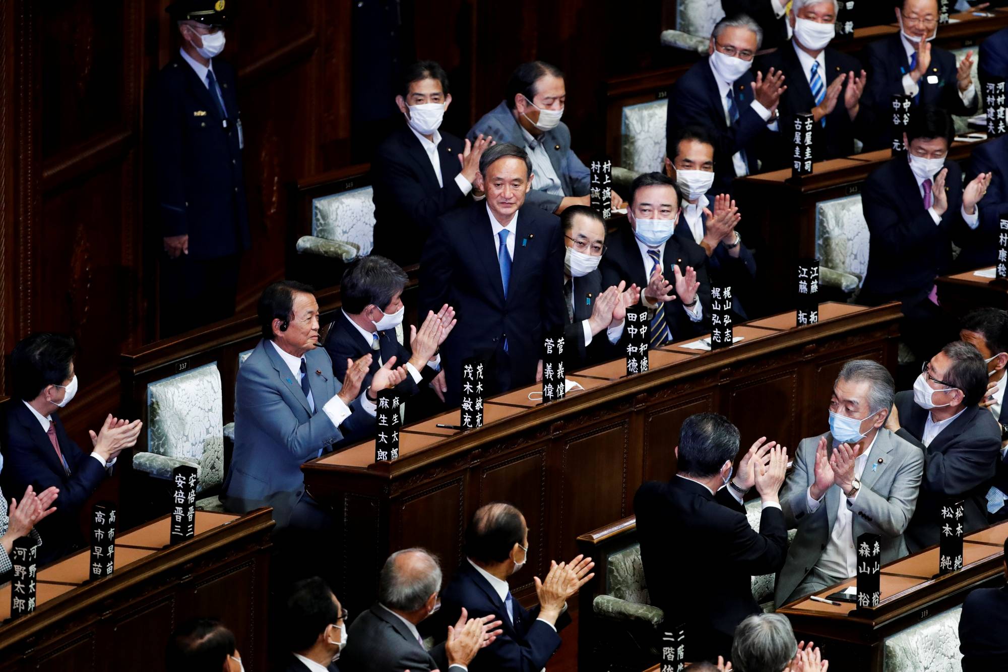 Yoshihide Suga stands to a round of applause in the Lower House after being selected to be the new prime minister of Japan in September. If he looks serious, that’s because he has a challenging job ahead of him in leading the nation during such an uncertain time. He was initially welcomed, with an approval rating of 65%, but this has since plunged to 42% amid criticisms of the Go To travel campaign and a rise in new cases of COVID-19. | REUTERS