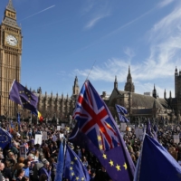Demonstrators gather in front of the Houses of Parliament in London following an anti-Brexit, pro-European Union march in March 2017.  | AFP-JIJI