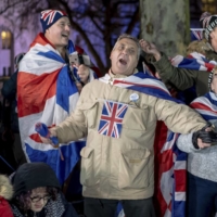 People celebrate in London as Britain officially leaves the European Union on Jan. 31, 2020. Britain and the European Union struck a trade deal on Thursday, setting the terms of their commercial relations after Britain completes its hard-fought split from the European Union on Dec. 31.  | ANDREW TESTA / THE NEW YORK TIMES