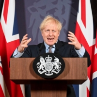 British Prime Minister Boris Johnson holds a news conference in London on Thursday.  | POOL / VIA REUTERS 