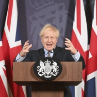 U.K. Prime Minister Boris Johnson speaks during a media briefing in London on Thursday.  | POOL / VIA AP