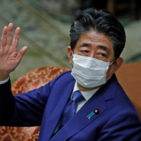 Former Prime Minister Shinzo Abe gestures while attending a session of the Diet\'s Lower House in Tokyo on Friday to face questioning over a possible violation of election funding laws. | REUTERS