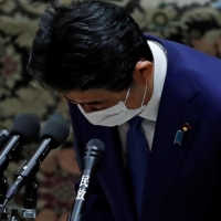 Former Prime Minister Shinzo Abe bows at the start of a session of the Diet\'s Lower House in Tokyo on Friday, where he was set to face questions over a possible violation of election funding laws. | REUTERS