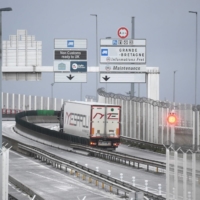 Trucks depart for England via the Channel Tunnel at the port of Calais on Friday.  | AFP-JIJI