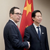 U.S. Treasury Secretary Steven Mnuchin (left) meets with Xiao Jie, China\'s finance minister, on the sidelines of the 2017 spring meetings of the International Monetary Fund and World Bank held in in Washington. | BLOOMBERG
 