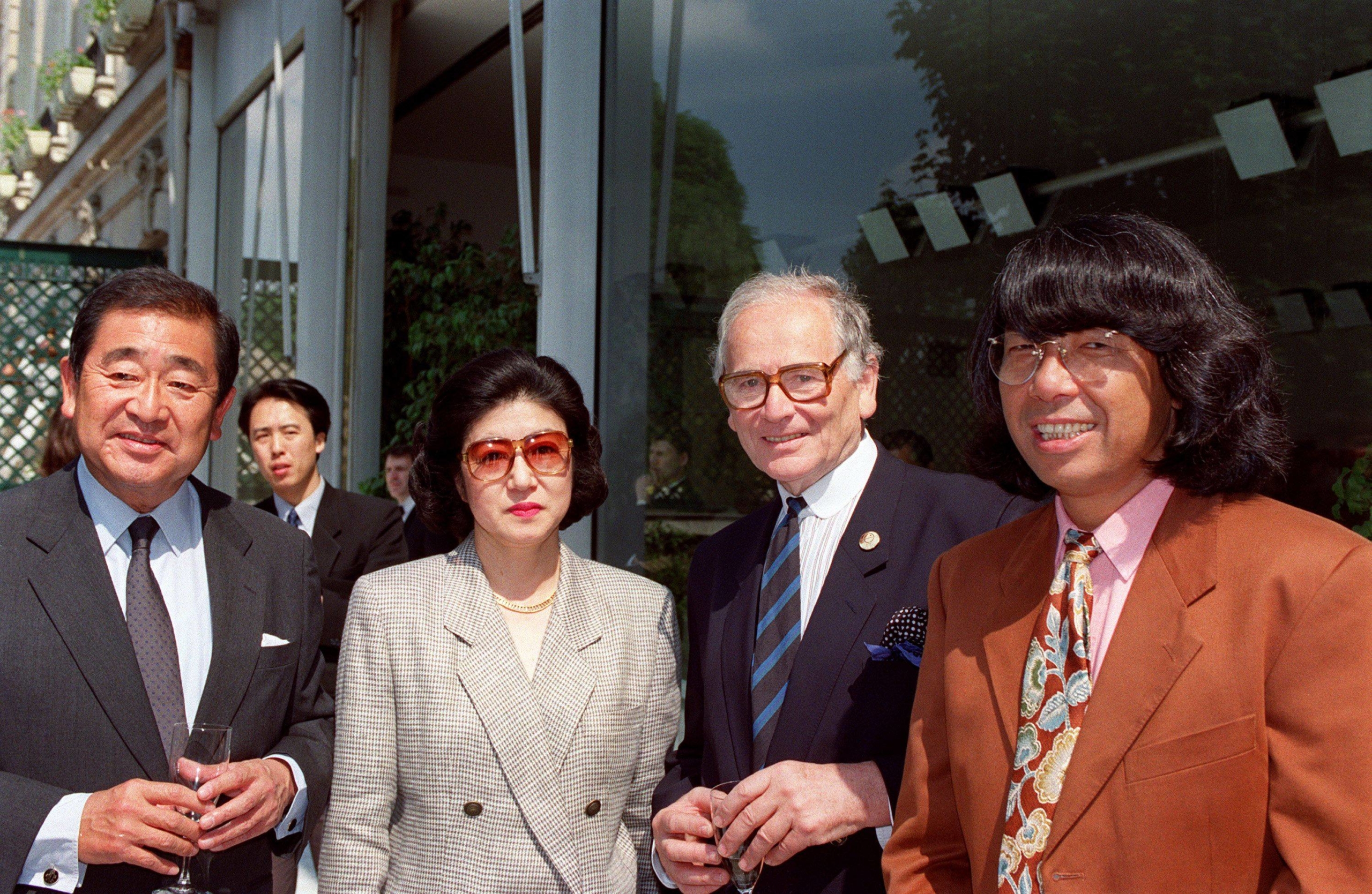 Cardin flanked by Japanese designer Kenzo (right), Japanese Ambassador to Paris Kiuchi Akitane and his wife, Yukiko, after the designer was awarded Japan's Medal of the Holy Treasure at a ceremony in Paris, in honor of Cardin's work to promote fashion in Japan | AFP-JIJI
